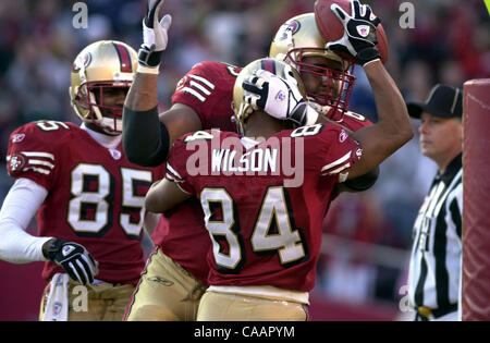 San Francisco 49ers Cedrick Wilson hugs Seattle Seahawk Jerry Rice