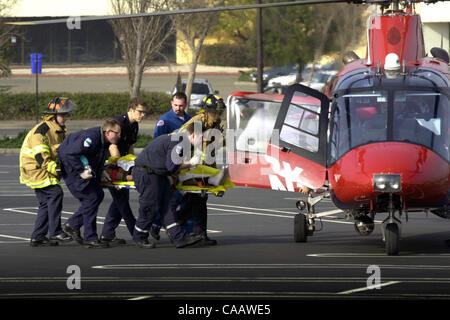 Paramedics transport a man from an ambulance to a medical helicopter on a Hilltop Mall parking lot in Richmond, Calif., on Thursday, Feb. 5, 2004. The man wrecked his car on nearby westbound Interstate 80 while trying to elude police.                      (Contra Costa Times/Mark DuFrene) Stock Photo