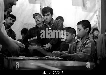 A free dinner for thousands is served in Taksim Square, Istanbul, on the first night of Ramadan, the Moslem month of fasting. Moslems do not eat from sunrise to sunset during the month of Ramadan. Stock Photo