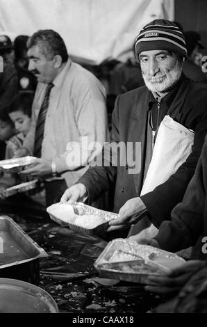 A free dinner for thousands is served in Taksim Square, Istanbul, on the first night of Ramadan, the Moslem month of fasting. Moslems do not eat from sunrise to sunset during the month of Ramadan. Stock Photo