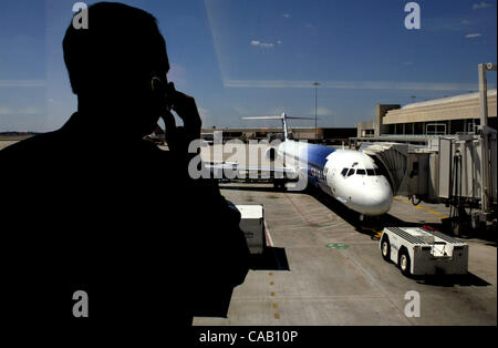 Mar 18, 2004; West Palm Beach, FL, USA; Palm Beach International Airport, GARY JAWORSKI (cq), of West Palm Beach, talks on a cell phone while waiting at the Spirit Airline terminal gate to board a flight to Atlantic City, New Jersey after it was delayed around four hours because of a bomb threat at  Stock Photo