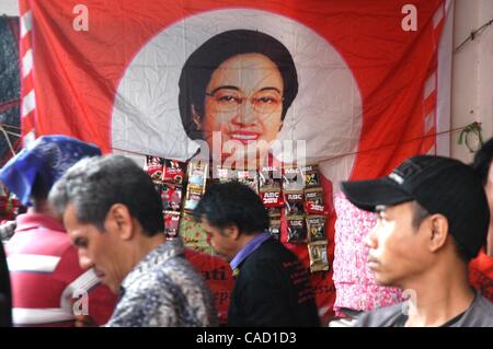 Jul 26, 2010 - Jakarta, Indonesia - Survivors of the 1996 tragedy and members of PDIP, President Megawati Sukarnoputri's political party offer flowers infornt of Suharto Potrait banner, during a ceremony in front of the ex-PDIP head office in Jakarta. PDIP members were attacked and arrested by unide Stock Photo