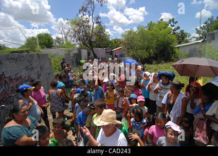 Aug 12, 2010 - Reynosa, Mexico - DIANNE HURMAN wades through a group of residents and their children waiting for food from the Frank Ferree Border Relief group in the colonia of Satelite Uno. (Credit Image: © Josh Bachman/ZUMApress.com) Stock Photo