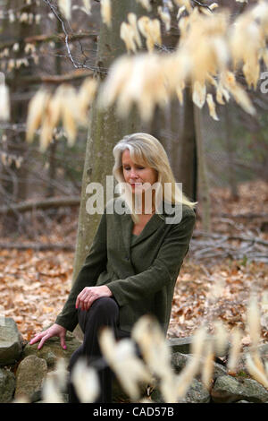 BONNIE MCENEANEY, author of 'Messages: Signs, Visits and Premonitions from Loved Ones Lost on 9/11'  at her home in New Canaan, Connecticut. She sits on a stone wall built by her late husband Eamon, who worked at Cantor Fitzgerald on the 105th floor of the North Tower and died in the attacks on the  Stock Photo