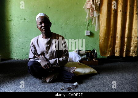 Aug. 5, 2010 - Kano, KANO, NIGERIA - Kabiru Nuhu, 50, has suffered from polio for many years. He and his  wife and children have survived with aid from the Kano State Polio Victims Trust Association. He sits in his home in Kano, Nigeria. .Religious zealotry and misinformation have coerced villagers  Stock Photo