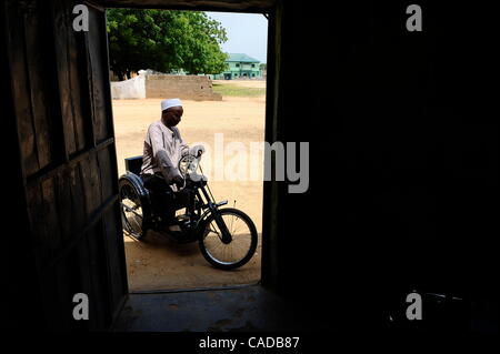 Aug. 5, 2010 - Kano, KANO, NIGERIA - Kabiru Nuhu, 50, has suffered from polio for many years. He and his  wife and children have survived with aid from the Kano State Polio Victims Trust Association. He rides on his donated hand cranked wheelchair outside the door of his home in Kano, Nigeria. .Reli Stock Photo