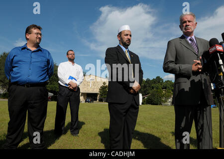 Sep 09, 2010 - Gainesville, Florida, U.S. - Rev. TERRY JONES, right, pastor of the Dove World Outreach Center announces the cancellation of the planned Quran burning after meeting with Imam MUHAMMAD MUSRI, center, president of the Islamic Society of Central Florida, outside Jones's church. Rev. Terr Stock Photo