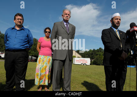 Sep 09, 2010 - Gainesville, Florida, U.S. - Rev. TERRY JONES, center, pastor of the Dove World Outreach Center listens to Imam MUHAMMAD MUSRI, right, president of the Islamic Society of Central Florida, after Jones announced the cancellation of the planned Quran burning outside Jones's church. Rev.  Stock Photo