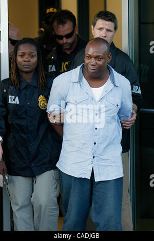 Jun 24, 2010 - White Plains, New York, USA - Jamaican gang leader and drug lord CHRISTOPHER 'DUDUS' COKE, 42, is escorted by DEA agents from the Avitat terminal at the Westchester County airport to a waiting vehicle. Coke arrived in the United States after being extradited from Jamaica to face drug  Stock Photo