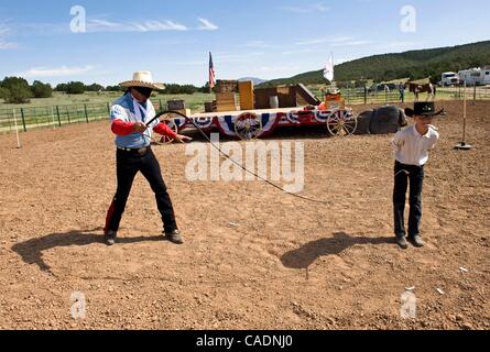 June 25, 2010 - Edgewood, New Mexico, USA -  A blindfolded DAN MINK, alias 'The Rhinestone Roper,' works with 12 year-old volunteer LYLE BRYSON, alias 'Young Gun,' at End of Trail, the Single Action Shooting Society's annual week-long World Championship of Cowboy Action Shooting and Wild West Jubile Stock Photo