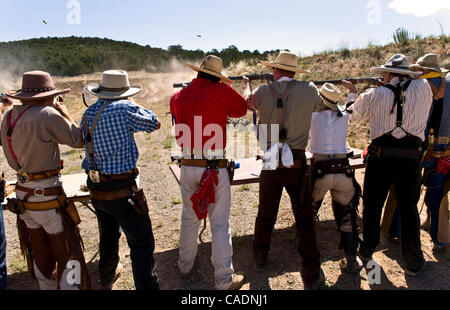 June 25, 2010 - Edgewood, New Mexico, USA -  A posse unleashes a barrage of gunfire at targets during End of Trail, the Single Action Shooting Society's annual week-long World Championship of Cowboy Action Shooting and Wild West Jubilee.  Dedicated to preserving the history and traditions of the Old Stock Photo