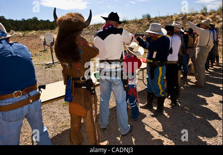 June 25, 2010 - Edgewood, New Mexico, USA - A posse unleashes a barrage of gunfire at targets during a timed shooting scenario at End of Trail, the Single Action Shooting Society's annual week-long World Championship of Cowboy Action Shooting and Wild West Jubilee.  Dedicated to preserving the histo Stock Photo