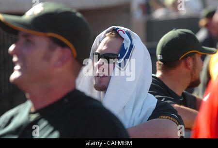 Oakland Athletics first baseman Daric Barton, center uses a towel to keep cool as temperatures reached the mid 80's during a Spring Training game against the Milwaukee Brewers at Phoenix Municipal Stadium in Phoenix, Ariz. on Friday February 29, 2008.  The A's won 11-4.  (Nader Khouri/Contra Costa T Stock Photo