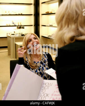 Feb 21, 2008 - Palm Beach Gardens, Florida, USA - CHARLA KRUPP, 55, left, style expert and author, signs her book 'How Not To Look Old' for Mary Murray, of Jupiter, at Bloomingdale's at the Gardens Mall in Palm Beach Gardens Thursday. (Credit Image: © Gary Coronado/Palm Beach Post/ZUMA Press) RESTRI Stock Photo