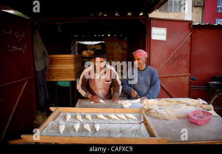 Feb 21, 2008 - Baghdad, Iraq -  Bakers roll dough for bread on the street in the Fish Market in the Sunni enclave of Shabakar in the Rabi neighborhood of Baghdad. (Credit Image: © Andrew Craft/ZUMA Press) Stock Photo