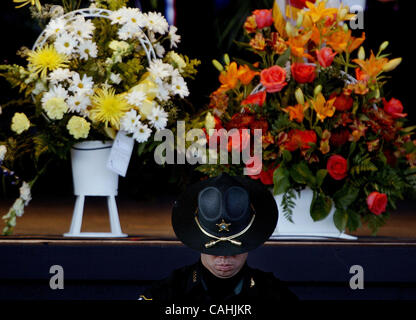 120507 pbso tj 8 -- Palm Beach Post staff photo by Taylor Jones/0045802D. FOR TEAM COVERAGE. SUBURBAN WEST PALM BEACH. A law enforcement officer stands with one of the caskets during the funeral of Palm Beach County Sheriff's Office deputies Donta Manuel and Jonathan Wallace(cq) at Sound Advice Ampi Stock Photo