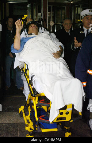 Firefighter Brian Smith, 43, of Ladder Company 44, waves as he is released from New York-Presbyterian Weill Cornell Medical Center on East 68th Street. Smith fell 30 feet from a ladder bucket while fighting a fire in the Bronx 22 days ago and suffers from a broken C1 vertebra, a cracked pelvis, punc Stock Photo