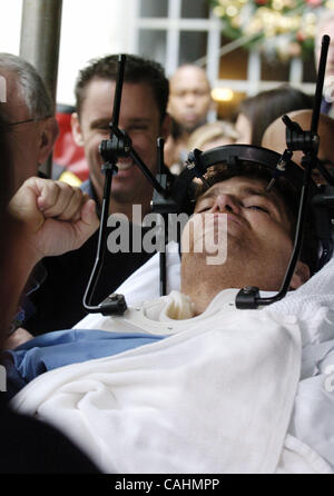 Firefighter Brian Smith, 43, of Ladder Company 44, pumps his fist as he is released from New York-Presbyterian Weill Cornell Medical Center on East 68th Street. Smith fell 30 feet from a ladder bucket while fighting a fire in the Bronx 22 days ago and suffers from a broken C1 vertebra, a cracked pel Stock Photo