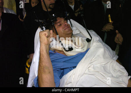 Firefighter Brian Smith, 43, of Ladder Company 44, pumps his fist as he is released from New York-Presbyterian Weill Cornell Medical Center on East 68th Street. Smith fell 30 feet from a ladder bucket while fighting a fire in the Bronx 22 days ago and suffers from a broken C1 vertebra, a cracked pel Stock Photo