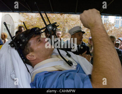 Firefighter Brian Smith, 43, of Ladder Company 44, pumps his fist as he is released from New York-Presbyterian Weill Cornell Medical Center on East 68th Street. Smith fell 30 feet from a ladder bucket while fighting a fire in the Bronx 22 days ago and suffers from a broken C1 vertebra, a cracked pel Stock Photo