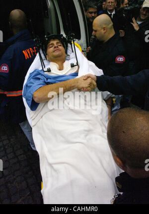 Firefighter Brian Smith, 43, of Ladder Company 44 is released from New York-Presbyterian Weill Cornell Medical Center on East 68th Street. Smith fell 30 feet from a ladder bucket while fighting a fire in the Bronx 22 days ago and suffers from a broken C1 vertebra, a cracked pelvis, punctured lungs a Stock Photo