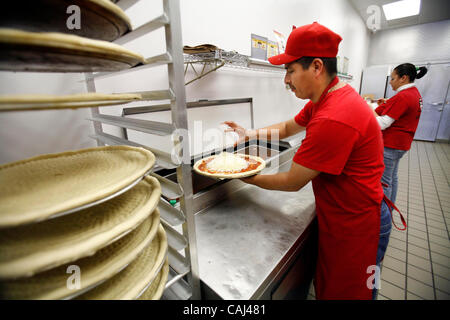 Pizza chef Leon Valtazar works at Pizza Patron, the premier Latino pizza brand, recently signed with popular radio personality Piolin to endorse the concept. As part of the company marketing campaign, the chain licensed the use of Piolin's image and highly-recognized logo for their marketing, advert Stock Photo