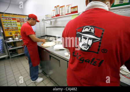 Pizza chef Leon Valtazar works at Pizza Patron, the premier Latino pizza brand, recently signed with popular radio personality Piolin to endorse the concept. As part of the company marketing campaign, the chain licensed the use of Piolin's image and highly-recognized logo for their marketing, advert Stock Photo