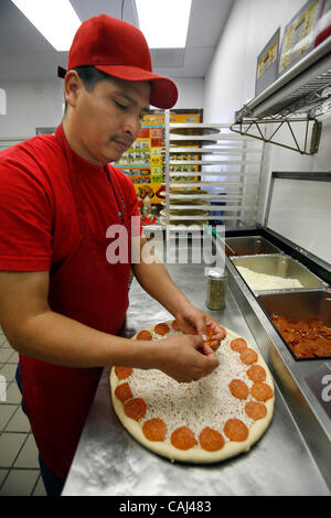 Pizza chef Leon Valtazar works at Pizza Patron, the premier Latino pizza brand, recently signed with popular radio personality Piolin to endorse the concept. As part of the company marketing campaign, the chain licensed the use of Piolin's image and highly-recognized logo for their marketing, advert Stock Photo