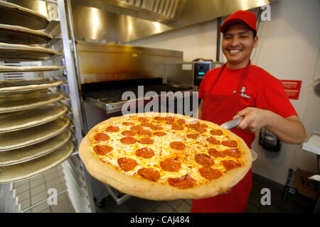 Pizza chef Leon Valtazar works at Pizza Patron, the premier Latino pizza brand, recently signed with popular radio personality Piolin to endorse the concept. As part of the company marketing campaign, the chain licensed the use of Piolin's image and highly-recognized logo for their marketing, advert Stock Photo