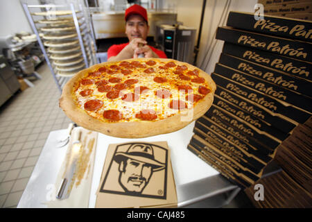 Pizza chef Leon Valtazar works at Pizza Patron, the premier Latino pizza brand, recently signed with popular radio personality Piolin to endorse the concept. As part of the company marketing campaign, the chain licensed the use of Piolin's image and highly-recognized logo for their marketing, advert Stock Photo