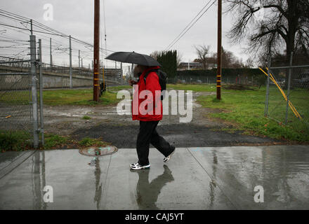 A pedestrian walks along 19th street where the new city park is proposed. The city of Sacramento is in the process of buying its first piece of central parkland in more than 30 years - a half acre of polluted land next to the light rail tracks in midtown pictured here along 19th Street Tuesday, Janu Stock Photo