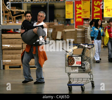 Subject: Ikea Man Lives in the Store Caption: Comedian and filmmaker MARK MALKOFF of Astoria, Queens, NY is living at the Ikea store in Paramus, New Jersey for one week while his apartment is fumigated. Here he continues his journey back to his 'apartment' relying on shopper-power to get  'home' fro Stock Photo