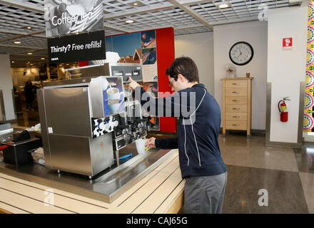 Subject: Ikea Man Lives in the Store Caption: Comedian and filmmaker MARK MALKOFF of Astoria, Queens, NY is living at the Ikea store in Paramus, New Jersey for one week while his apartment is fumigated. Here he gets a cup of coffee at the cafe. The lights stay on much of the night, and construction  Stock Photo