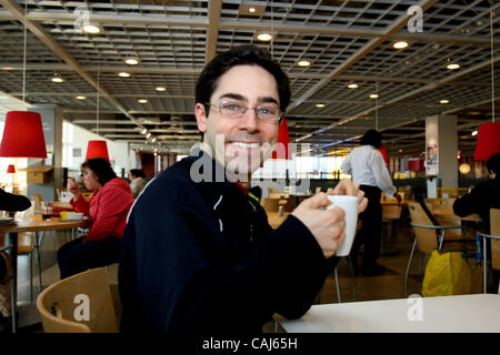 Subject: Ikea Man Lives in the Store Caption: Comedian and filmmaker MARK MALKOFF of Astoria, Queens, NY is living at the Ikea store in Paramus, New Jersey for one week while his apartment is fumigated. Here he has a cup of coffee in the cafe. He is making a film of his Ikea adventure, and there are Stock Photo