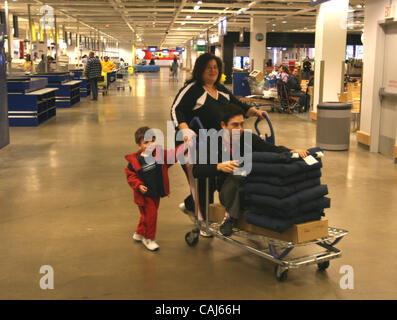 Subject: Ikea Man Lives in the Store Caption: Comedian and filmmaker MARK MALKOFF of Astoria, Queens, NY is living at the Ikea store in Paramus, New Jersey for one week while his apartment is fumigated. Here he continues his journey back to his 'apartment' relying on shopper-power to get  'home' fro Stock Photo