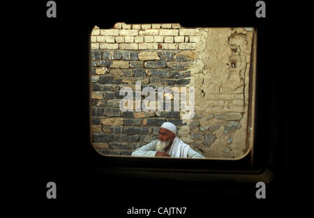 Sep 27, 2007 - Bak, Khost, Afghanistan - Photos taken through side window of US Army Humvee. A man squats against a wall and watches a convoy of Humvees drive by in the Bak district of Afghanistan (Credit Image: © Andrew Craft/The Fayetteville Observer/ZUMA Press) Stock Photo