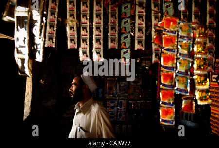 Sep 28, 2007 - Khoshki Daudah, Afghanistan - Hair dye packets hang from the ceiling as a shopkeeper looks out the window of his store at paratroopers of the 2nd Battilion, 321st Field Artillery Regiment, 82nd Airborne Division, while they talk with a group of Afghan men in Khoshki Daudah. (Credit Im Stock Photo