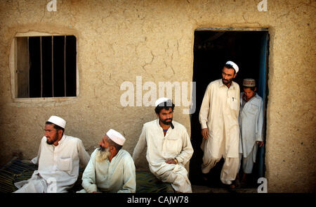 Sep 28, 2007 - Khoshki Daudah, Afghanistan - Afghan men gather outside a store to talk with paratroopers, from the 2nd Battilion, 321st Field Artillery Regiment, 82nd Airborne Division, in Khoshki Daudah about the construction of the new Sabari district center and if they have any information on Tal Stock Photo