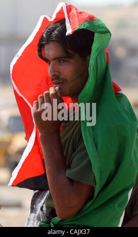 Oct 01, 2007 - Gaza City, Palestinian Territories - Palestinians wear  their country's palestinian  flag they wait for relatives released from Israeli prisons, at the Erez crossing, northern Gaza Strip. Israel was to release 87 Palestinian prisoners today as a goodwill gesture to president Mahmud Ab Stock Photo