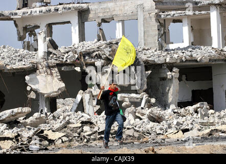 Oct 01, 2007 - Gaza City, Palestinian Territories - A Palestinian boy carrying a yellow Fatah flag as he waits along with hundred others for relatives released from Israeli prisons, at the Erez crossing, northern Gaza Strip. Israel was to release 87 Palestinian prisoners today as a goodwill gesture  Stock Photo