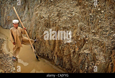 Oct 02, 2007 - Khost, Afghanistan - An Afghan child works on clearing dirt from an irrigation stream in the Khost Gardez Pass. (Credit Image: © Andrew Craft/The Fayetteville Observer/ZUMA Press) Stock Photo