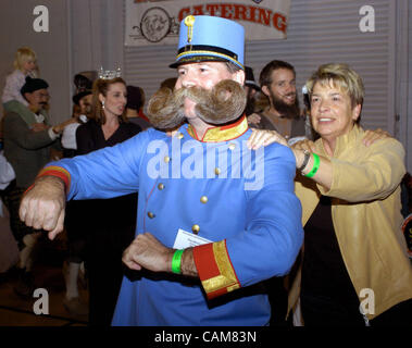 Nov. 01, 2003 - Carson City, Nevada, USA - Austrian Franz Mitterhauser leads a group of revelers around the Carson City, Nevada Community Center to the strains of an oompah band during an intermission in the World Beard and Moustache Championships.  Bearded and moustachioed men from 11 countries cha Stock Photo