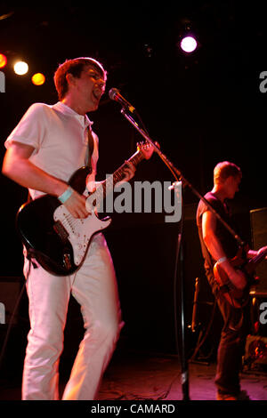 The Cinematics performing at The Bowery Ballroom on September 4, 2007.  Scott Rinning - Guitar/Lead Vocals (all white outfit) Ramsay Miller - Guitar/Backing Vocals (white shirt, dark pants) Adam Goemans - Bass (all dark outfit) Ross Bonney - Drums Stock Photo