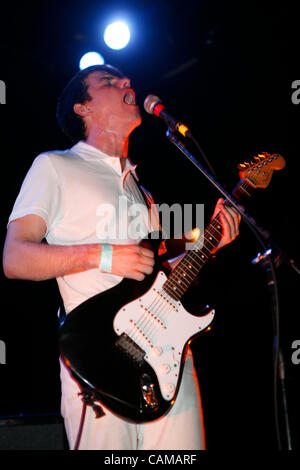 The Cinematics performing at The Bowery Ballroom on September 4, 2007.  Scott Rinning - Guitar/Lead Vocals (all white outfit) Ramsay Miller - Guitar/Backing Vocals (white shirt, dark pants) Adam Goemans - Bass (all dark outfit) Ross Bonney - Drums Stock Photo