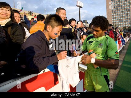 Australia's  Shannon Walker signs his autograph for a young Japanese fan after the final of  the rugby 7s world series in Tokyo, Japan on 01 April, 2012. Australia beat Samoa in the final 28-26.  Photographer: Robert Gilhooly Stock Photo