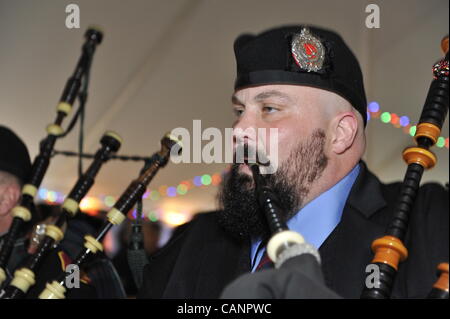 Bagpiper paying bagpipes, in Boston Gaelic Fire Brigade Pipes and Drums, at fund raiser for firefighter Ray Pfeifer - battling cancer after months of recovery efforts at Ground Zero after 9/11 attack - on March 31, 2012, at East Meadow Firefighters Benevolent Hall, New York, USA. Stock Photo