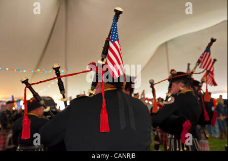 Bagpiper paying bagpipes, from behind, in Boston Gaelic Fire Brigade Pipes and Drums, at fund raiser for firefighter Ray Pfeifer- battling cancer after months of recovery efforts at Ground Zero after 9/11 attack - on March 31, 2012, at East Meadow Firefighters Benevolent Hall, New York, USA. Stock Photo