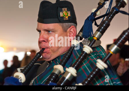 Bagpiper paying bagpipes, in Boston Gaelic Fire Brigade Pipes and Drums, at fund raiser for firefighter Ray Pfeifer - battling cancer after months of recovery efforts at Ground Zero after 9/11 attack - on March 31, 2012, at East Meadow Firefighters Benevolent Hall, New York, USA. Stock Photo