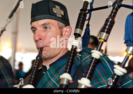 Bagpiper paying bagpipes, in Boston Gaelic Fire Brigade Pipes and Drums, at fund raiser for firefighter Ray Pfeifer- battling cancer after months of recovery efforts at Ground Zero after 9/11 attack - on March 31, 2012, at East Meadow Firefighters Benevolent Hall, New York, USA. Stock Photo