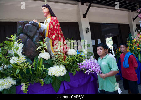 Cebu City, Philippines, 4.April 2012: Traditional Easter ceremonial parade with the Saints.  Preparations for the parade, man arranging flowers on the carroza. Stock Photo